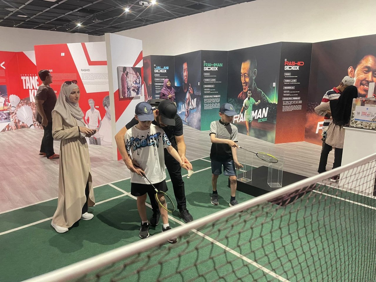 Pengunjung cuba membuat 'service' di Pameran Anak-anak Sidek: Lagenda Badminton Negara. - gambar PADAT